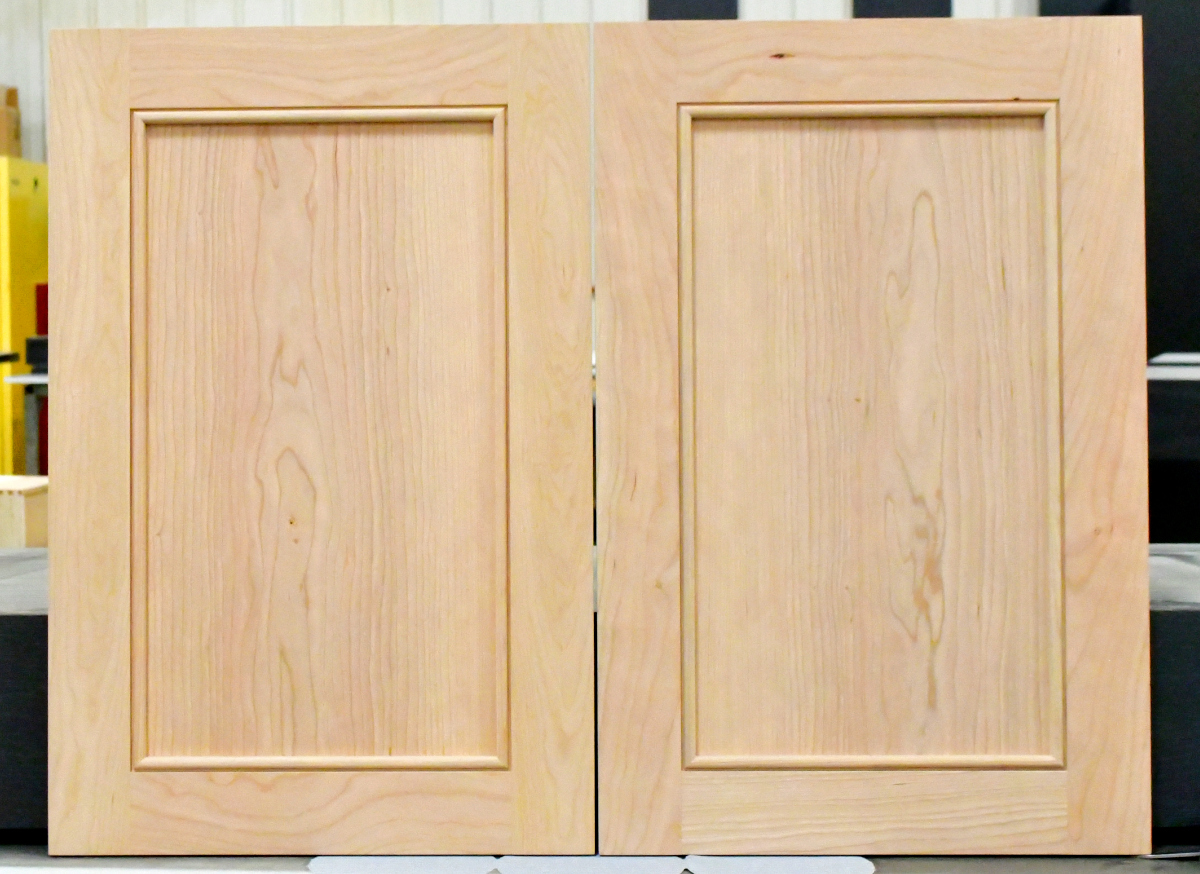 Two cherry wood cabinet doors that are finish sanded